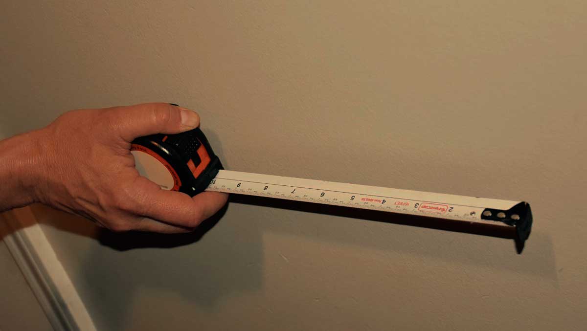 Use a tape measure to measure the walls